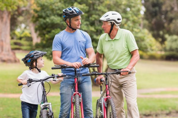 Happy multi generation family on their bike at the park on a sunny day